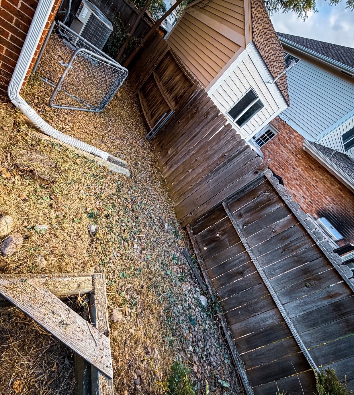 After: cleared side yard near fence and AC unit